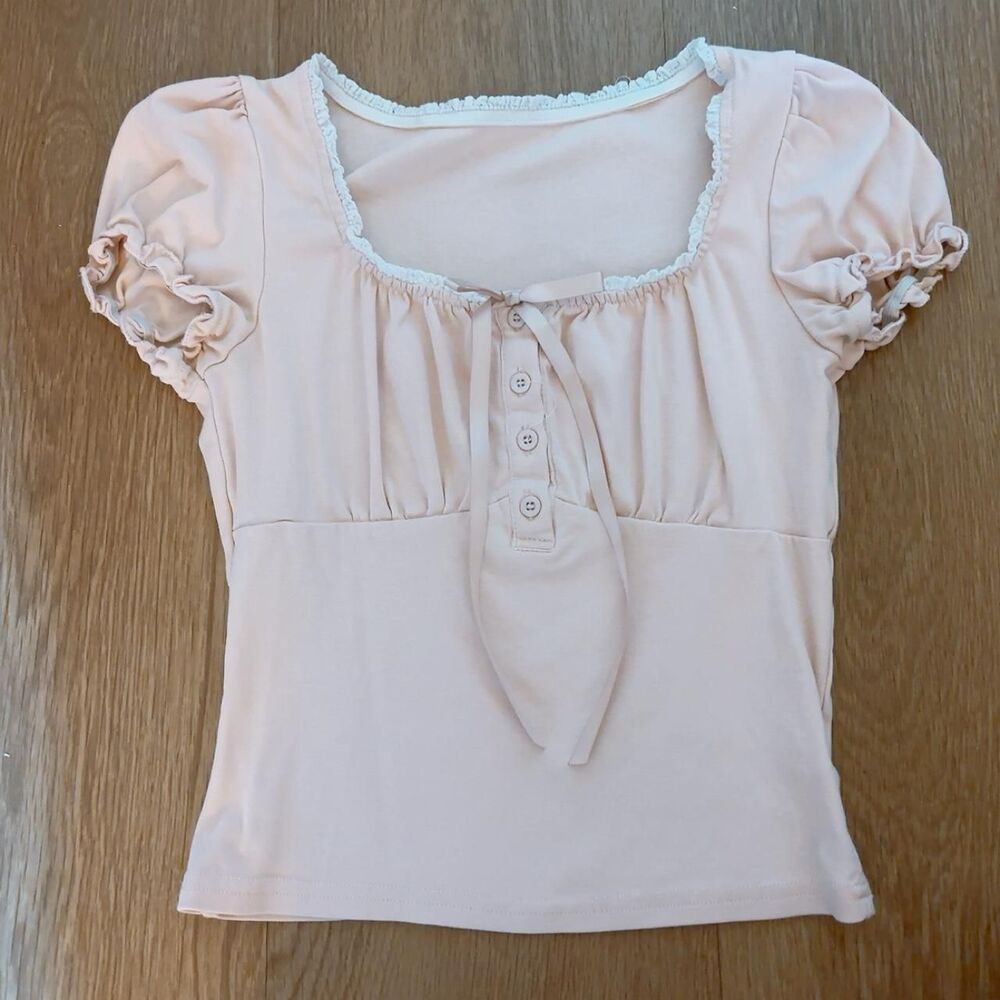 Pink babydoll blouse with ruffled sleeves and lace trim